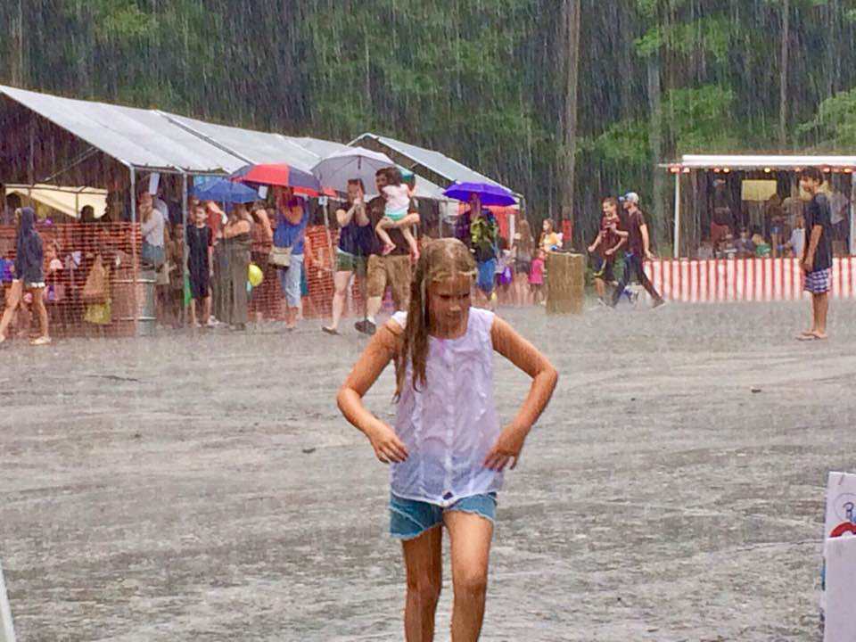 girl caught in a downpour at the Children's Fair