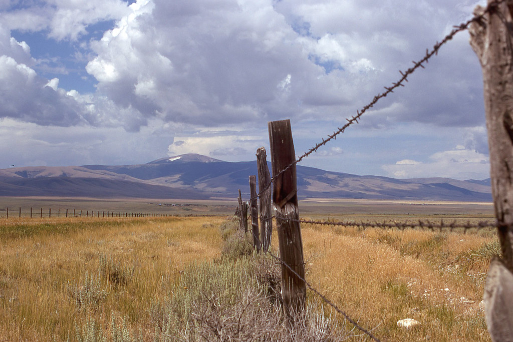 Barb wire fence and view of mountain, No trees.