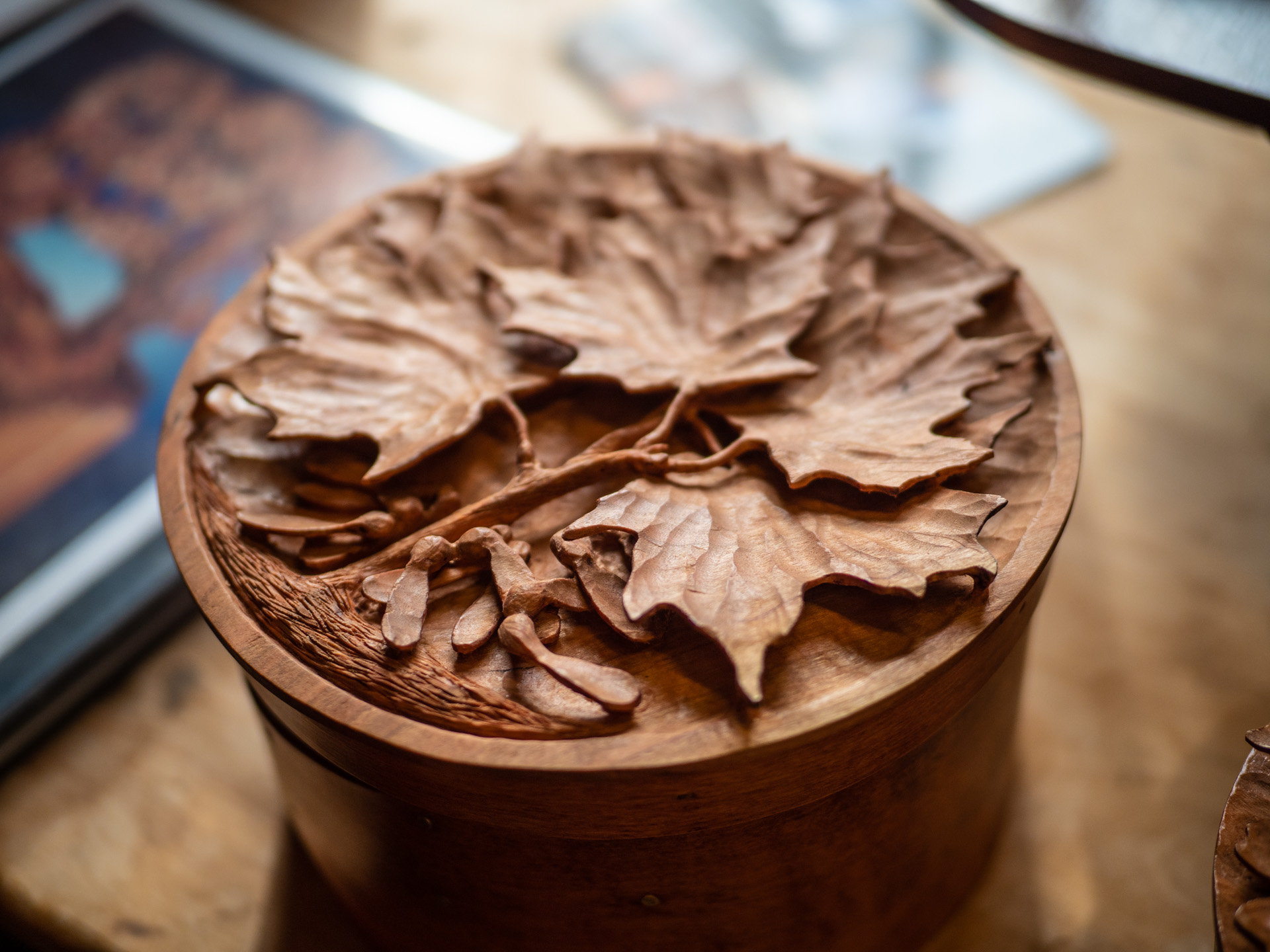 Maple leaf carving on top of a shaker box