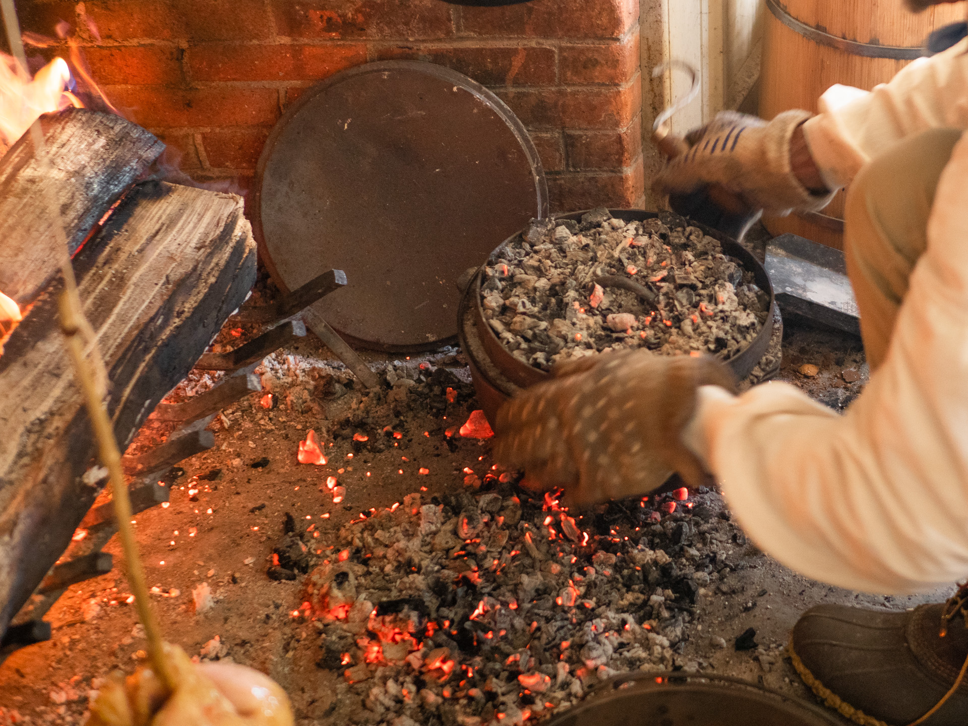 Cooking with a dutch oven covered with hot coals
