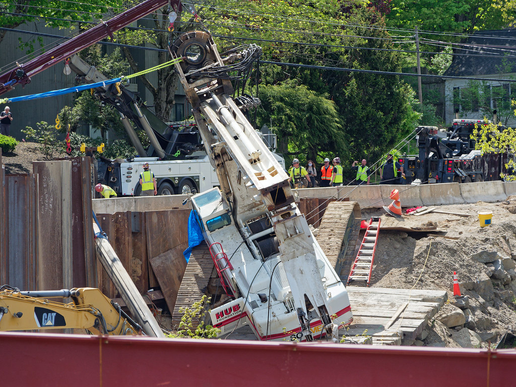 Towing a flipped drilling rig to an upright position