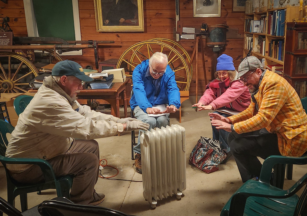New Ipswich Historical Society November Meeting 2024 Four NIHS members huddled around a space heater