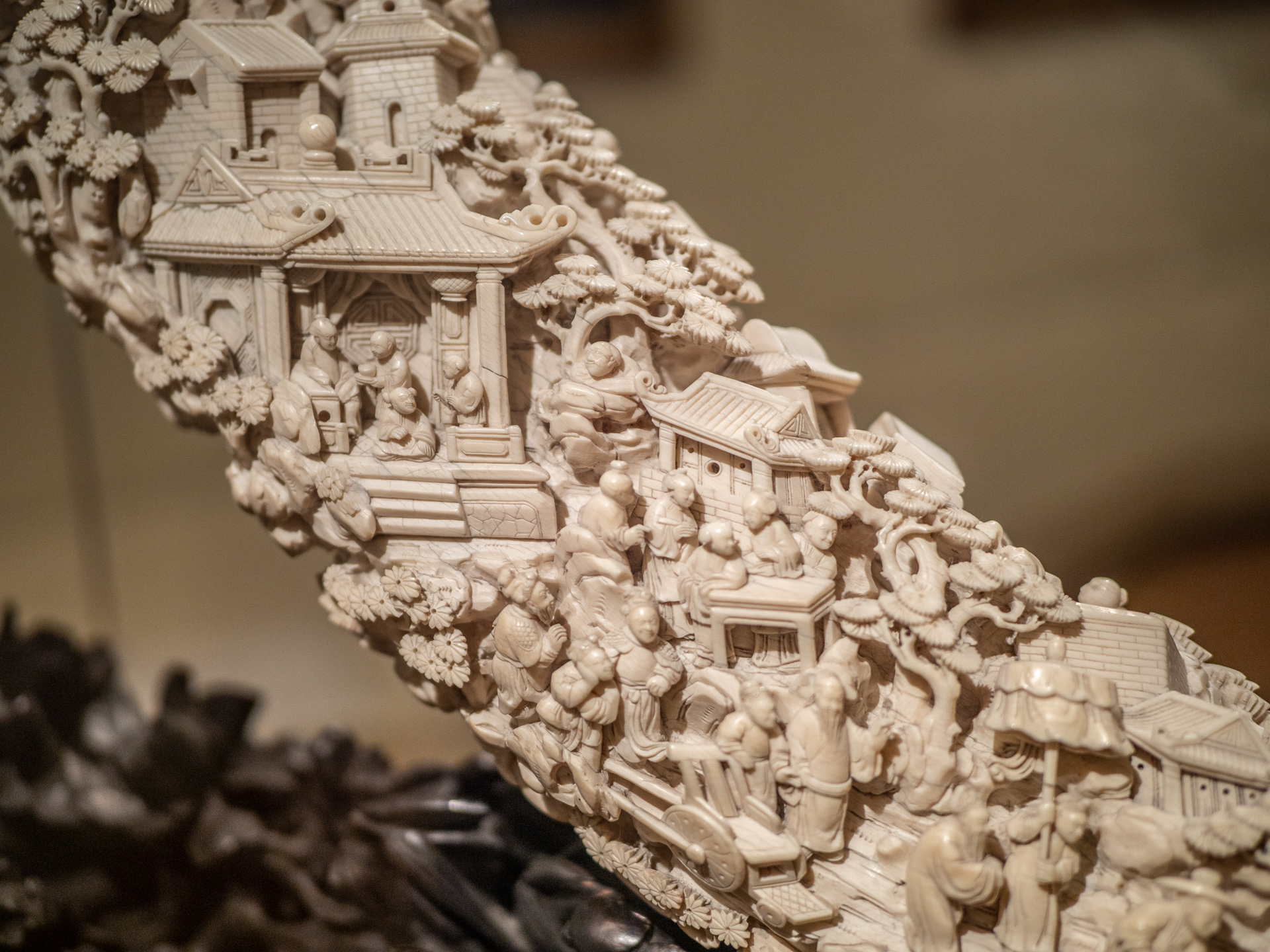 Carved tusk and stand, about 1839. Carving depicts scenes from traditional Chinese stories.