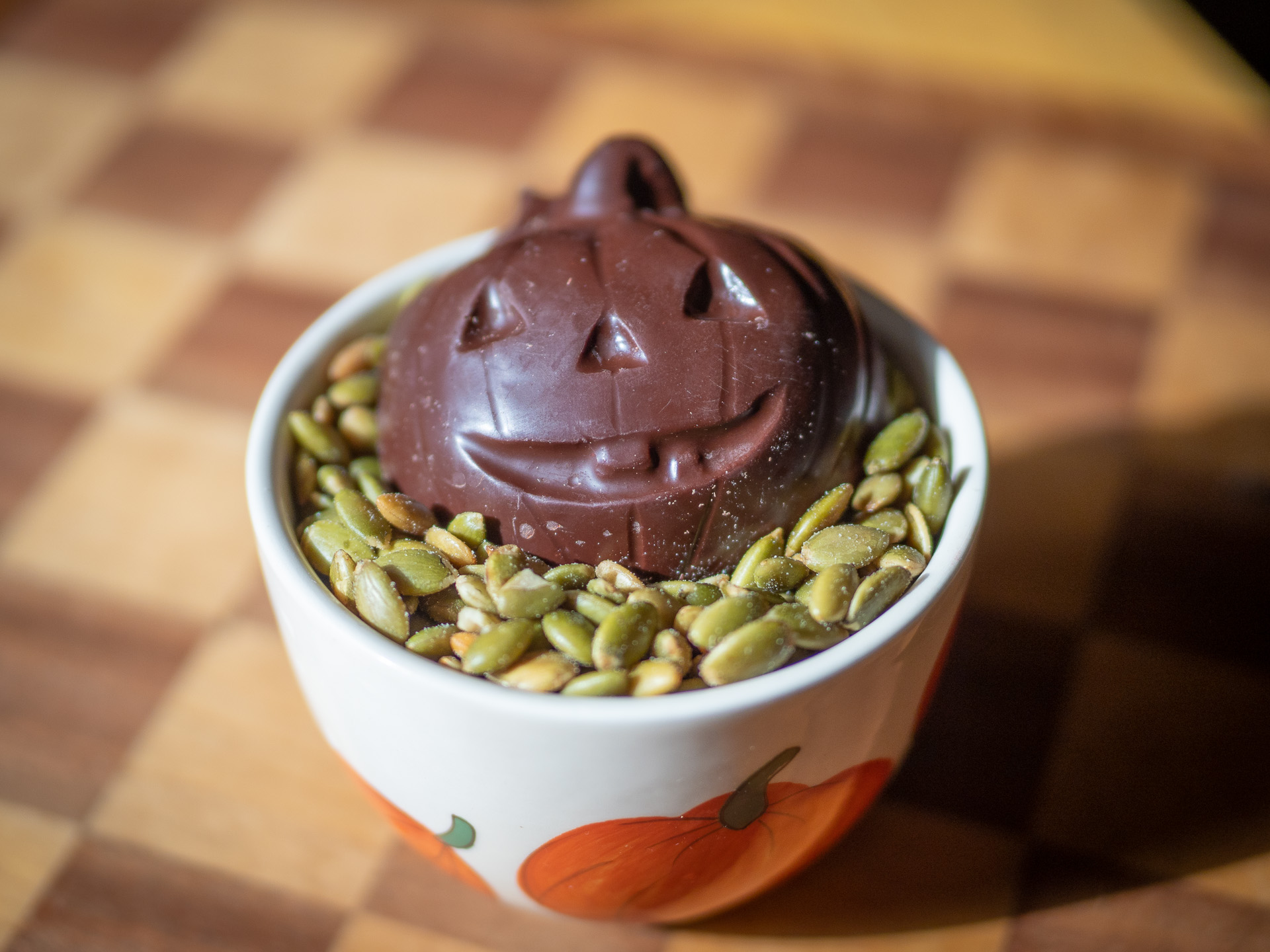 Chocolate Pumpkin in a bowl of pumpkins seeds