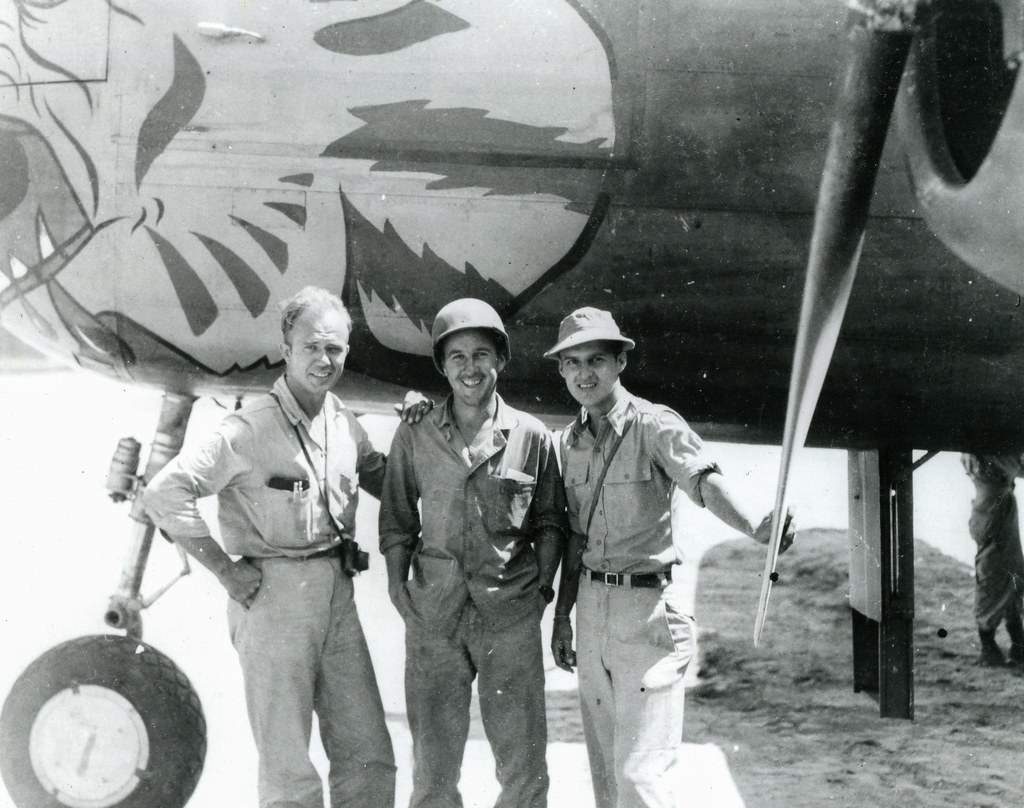 South Pacific Reunion Three men standing near a B-25 bomber in WWII