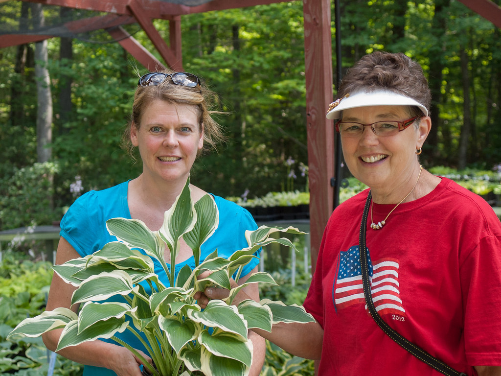 Sue Anderson (in flag shirt) with a customer at Mason Hollow Nursery